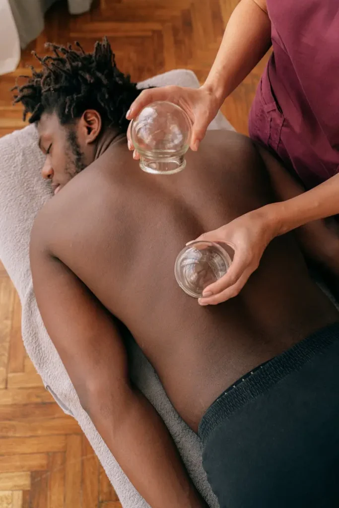 Male laying down having back cupping